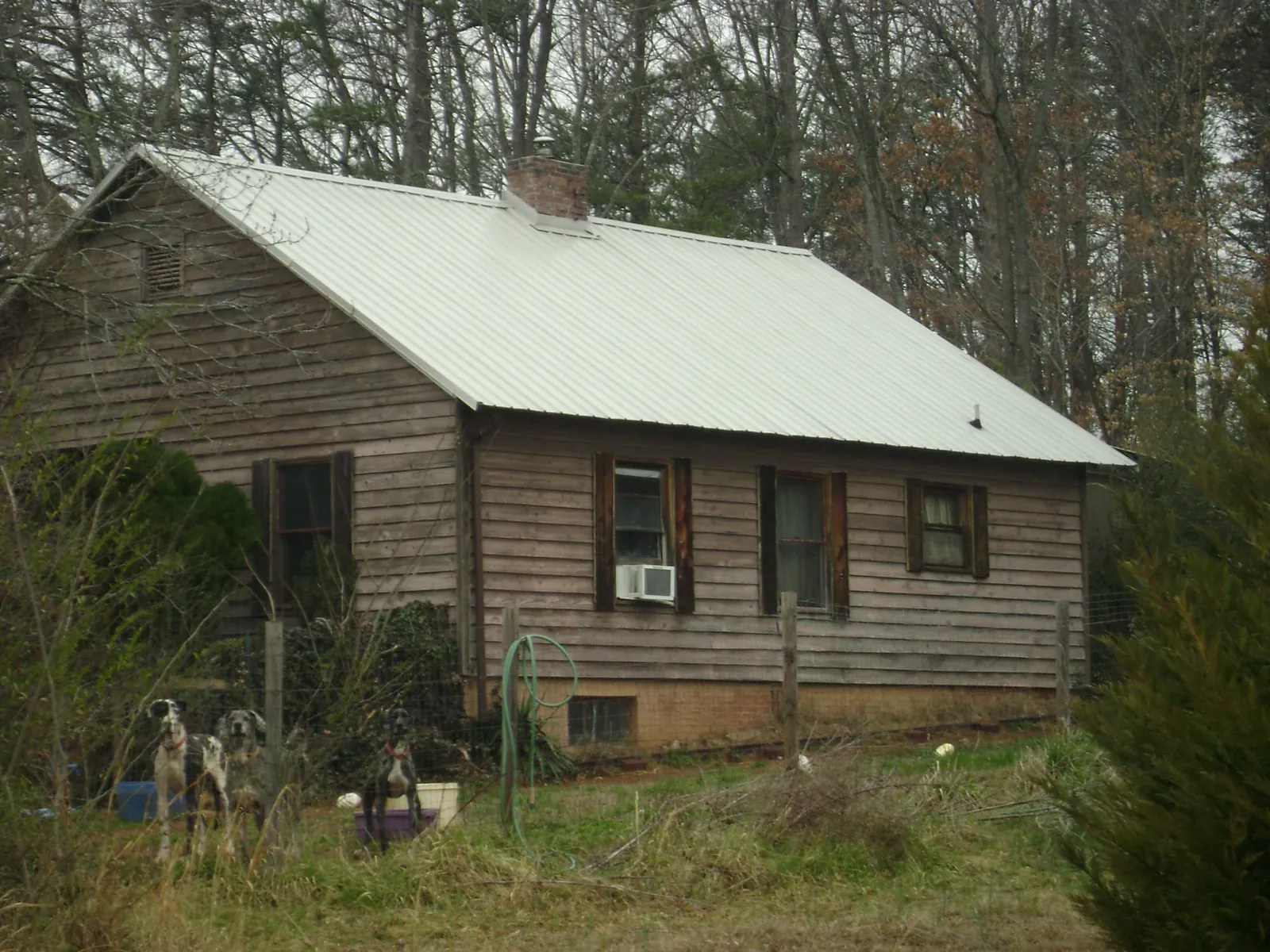 White metal roof on an old wood sided farmhouse, from a Metal Roof Installation job in Lamoure